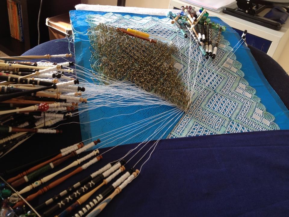 Lace being worked on a pillow